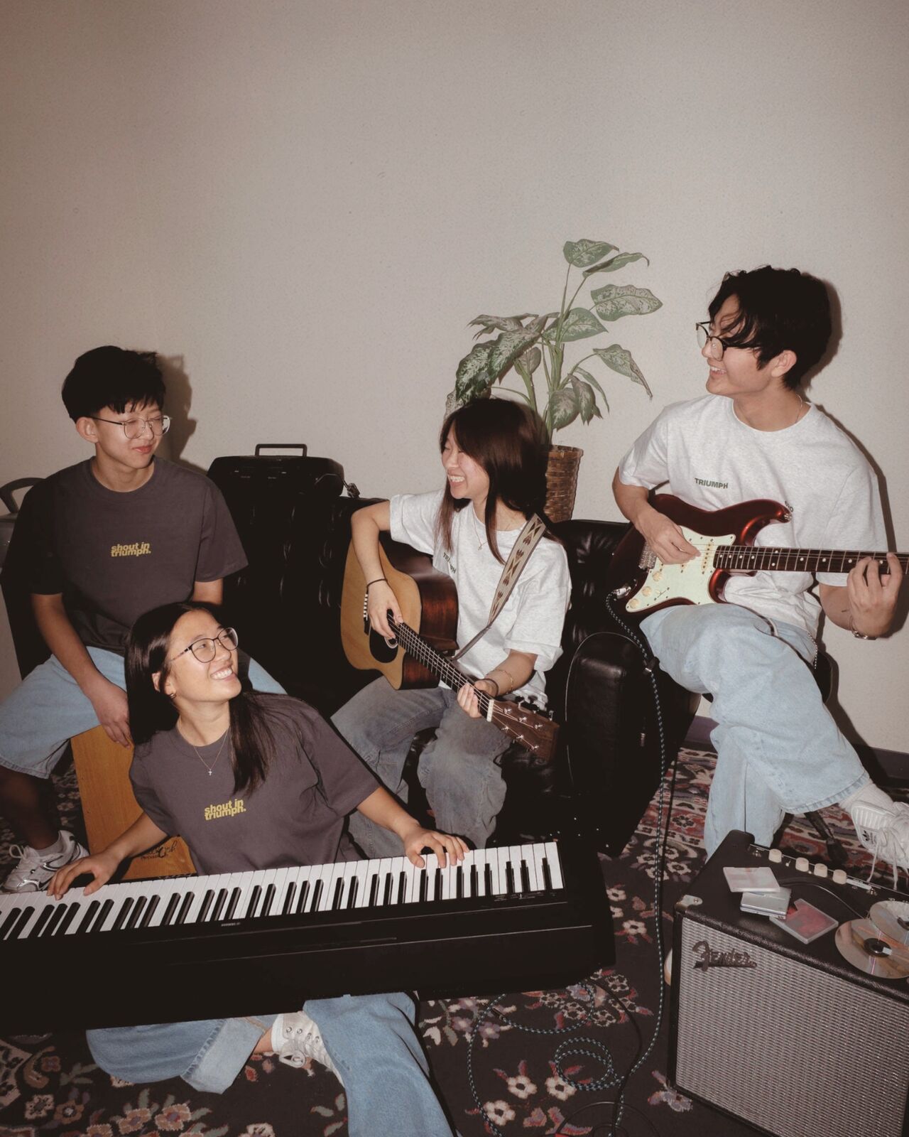 Four students jamming on keys, acoustic and electric guitar in the FW26 drop
