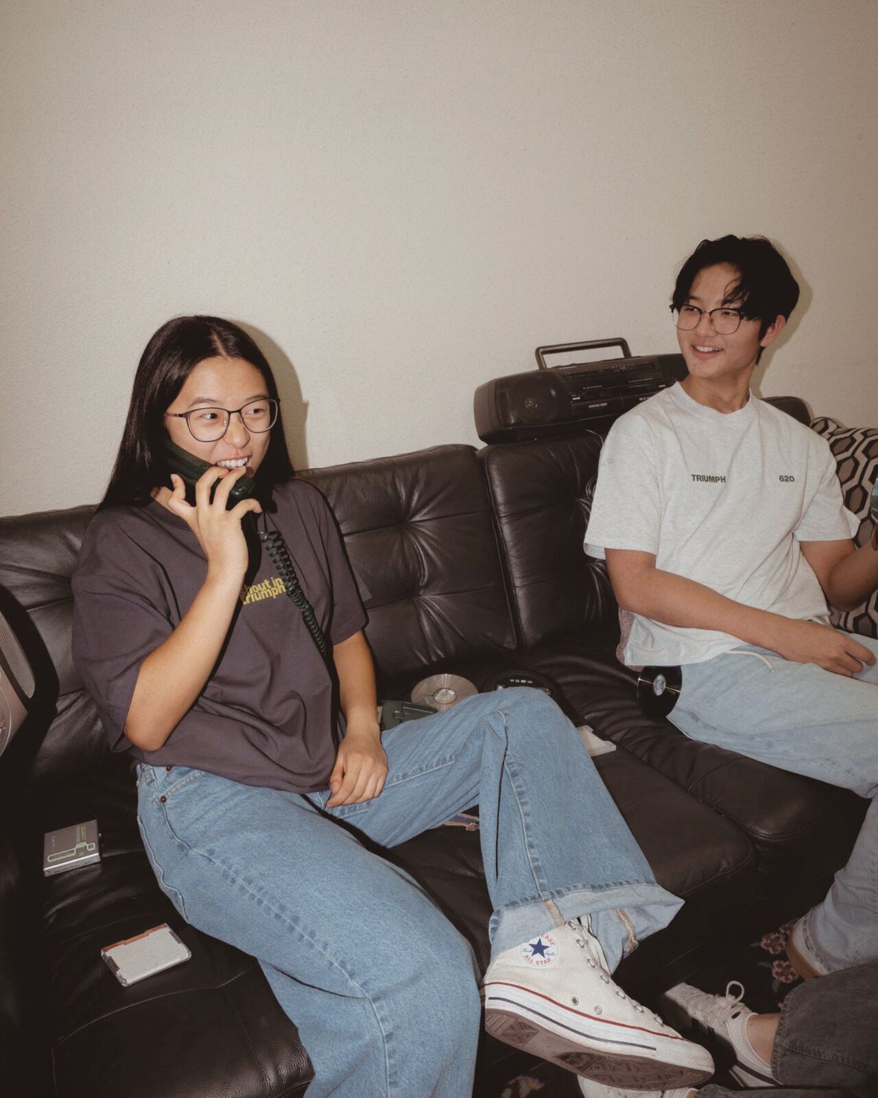 Student in the shout in triumph tee on a vintage phone