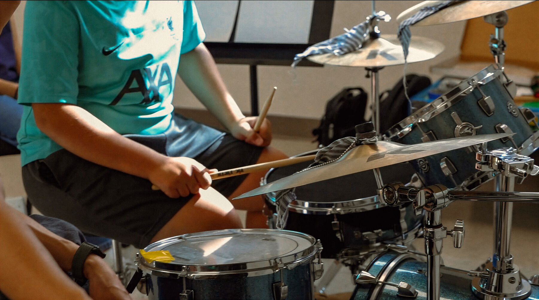 Student playing drums in a Ruwa Music School class