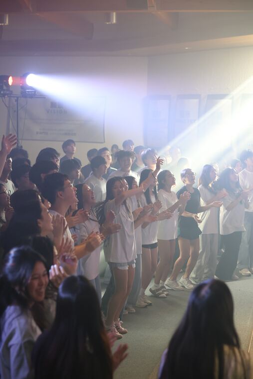 Students singing and clapping at a Ruwa Worship Night